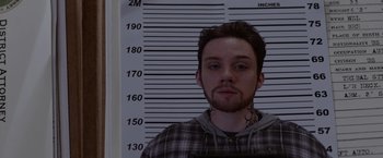 Movie still from “Secret in Their Eyes” (2015), directed by Billy Ray – A man in a plaid shirt is standing in front of a wall; Close Up shot, Low angle