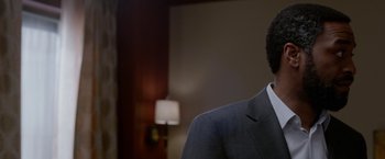 Movie still from “Secret in Their Eyes” (2015), directed by Billy Ray – A person wearing a suit and tie; Close Up shot, Over the shoulder angle
