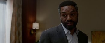 Movie still from “Secret in Their Eyes” (2015), directed by Billy Ray – A person wearing a suit and tie; Close Up shot, Over the shoulder angle