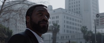 Movie still from “Secret in Their Eyes” (2015), directed by Billy Ray – A person wearing a suit and tie; Close Up shot, Low angle