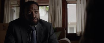 Movie still from “Secret in Their Eyes” (2015), directed by Billy Ray – A person wearing a suit and a tie; Close Up shot, Over the shoulder angle