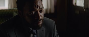 Movie still from “Secret in Their Eyes” (2015), directed by Billy Ray – A person wearing a suit and tie; Close Up shot, Over the shoulder angle
