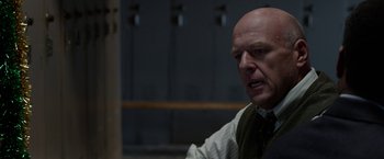 Movie still from “Secret in Their Eyes” (2015), directed by Billy Ray – A man with a bald head is looking at the camera; Close Up shot, Over the shoulder angle
