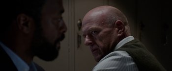 Movie still from “Secret in Their Eyes” (2015), directed by Billy Ray – A man with a shaved head stares at another man with a beard; Close Up shot, Over the shoulder angle
