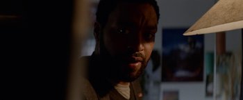 Movie still from “Secret in Their Eyes” (2015), directed by Billy Ray – A person looking at the camera; Close Up shot, Over the shoulder angle