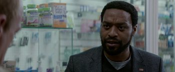 Movie still from “Secret in Their Eyes” (2015), directed by Billy Ray – A person wearing a suit and tie; Close Up shot, Over the shoulder angle