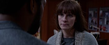 Movie still from “Secret in Their Eyes” (2015), directed by Billy Ray – A woman is looking at a man in a room; Close Up shot, Over the shoulder angle
