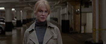 Movie still from “Secret in Their Eyes” (2015), directed by Billy Ray – A woman in a beige trench coat and a gray sweater; Close Up shot, Low angle