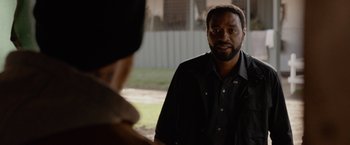 Movie still from “Secret in Their Eyes” (2015), directed by Billy Ray – A man standing in front of another man; Close Up shot, Over the shoulder angle