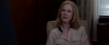 Movie still from “Secret in Their Eyes” (2015), directed by Billy Ray – A woman sitting in an office chair wearing a necklace; Close Up shot, Over the shoulder angle