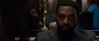 Movie still from “Secret in Their Eyes” (2015), directed by Billy Ray – A person wearing a suit and tie; Close Up shot, Low angle