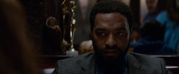 Movie still from “Secret in Their Eyes” (2015), directed by Billy Ray – A person wearing a suit and tie; Close Up shot, Over the shoulder angle