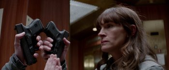 Movie still from “Secret in Their Eyes” (2015), directed by Billy Ray – A woman holding a gun up to her face; Close Up shot, Low angle