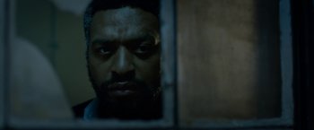 Movie still from “Secret in Their Eyes” (2015), directed by Billy Ray – A person looking out a window; Close Up shot, Over the shoulder angle