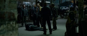 Movie still from “Secret in Their Eyes” (2015), directed by Billy Ray – A group of men standing around a man laying on the ground; Wide shot, High angle