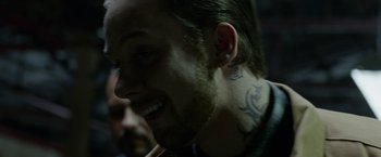 Movie still from “Secret in Their Eyes” (2015), directed by Billy Ray – A person with a tattoo on their face; Close Up shot, Over the shoulder angle