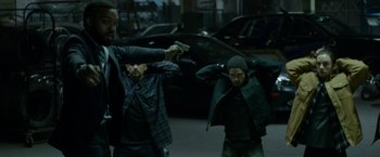 Movie still from “Secret in Their Eyes” (2015), directed by Billy Ray – A group of men standing next to each other on a street; Medium shot, High angle