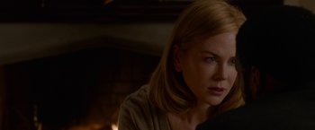 Movie still from “Secret in Their Eyes” (2015), directed by Billy Ray – A woman sitting in front of a fire place; Close Up shot, Over the shoulder angle