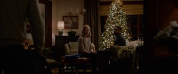 Movie still from “Secret in Their Eyes” (2015), directed by Billy Ray – Two people sitting in front of a christmas tree; Wide shot, Low angle