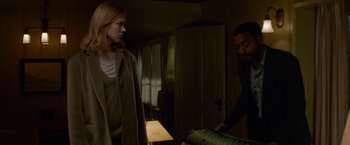 Movie still from “Secret in Their Eyes” (2015), directed by Billy Ray – A man and a woman standing in a living room; Medium shot, Low angle