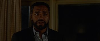 Movie still from “Secret in Their Eyes” (2015), directed by Billy Ray – A man with a beard and a suit; Close Up shot, Over the shoulder angle