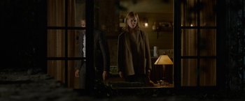 Movie still from “Secret in Their Eyes” (2015), directed by Billy Ray – A man and a woman standing in front of an open door; Wide shot, Over the shoulder angle