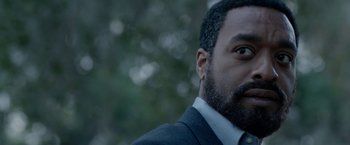 Movie still from “Secret in Their Eyes” (2015), directed by Billy Ray – A person wearing a suit and tie; Close Up shot, Over the shoulder angle