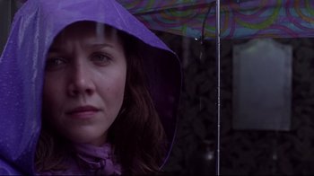 Movie still from “Secretary” (2002), directed by Steven Shainberg – A person with a purple umbrella; Close Up shot, Low angle