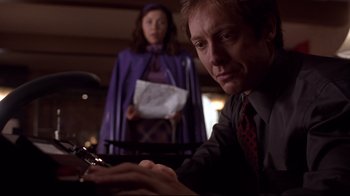 Movie still from “Secretary” (2002), directed by Steven Shainberg – A man and a woman looking at a cell phone; Close Up shot, Low angle