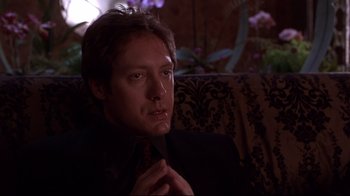 Movie still from “Secretary” (2002), directed by Steven Shainberg – A person wearing a suit and tie; Close Up shot, Low angle
