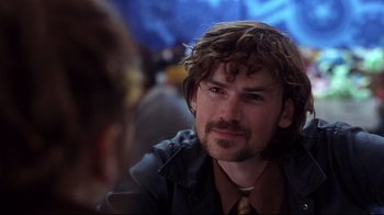 Movie still from “Secretary” (2002), directed by Steven Shainberg – A person wearing a suit and tie; Close Up shot, Over the shoulder angle