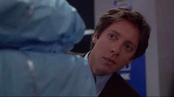 Movie still from “Secretary” (2002), directed by Steven Shainberg – A person wearing a suit and tie; Close Up shot, Over the shoulder angle