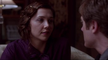 Movie still from “Secretary” (2002), directed by Steven Shainberg – A woman in a purple shirt talking to a man in a purple shirt; Close Up shot, Over the shoulder angle