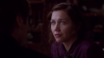 Movie still from “Secretary” (2002), directed by Steven Shainberg – A person sitting in a room; Close Up shot, Over the shoulder angle