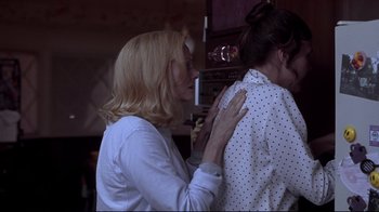 Movie still from “Secretary” (2002), directed by Steven Shainberg – A woman in a white shirt and a woman in a polka dot shirt; Medium shot, Over the shoulder angle