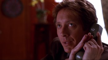 Movie still from “Secretary” (2002), directed by Steven Shainberg – A person talking on a phone; Close Up shot, Low angle