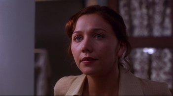 Movie still from “Secretary” (2002), directed by Steven Shainberg – A person looking at the camera; Close Up shot, Over the shoulder angle