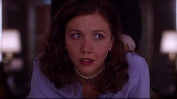 Movie still from “Secretary” (2002), directed by Steven Shainberg – A person wearing a purple shirt; Close Up shot, Over the shoulder angle