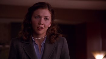 Movie still from “Secretary” (2002), directed by Steven Shainberg – A person wearing a suit; Close Up shot, Over the shoulder angle