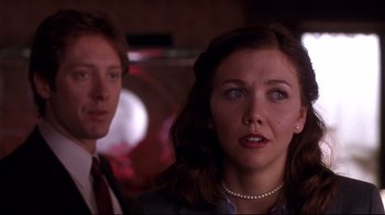Movie still from “Secretary” (2002), directed by Steven Shainberg – A man and a woman are looking into the camera; Close Up shot, Over the shoulder angle