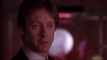 Movie still from “Secretary” (2002), directed by Steven Shainberg – A person wearing a suit and tie; Close Up shot, Low angle