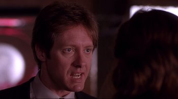 Movie still from “Secretary” (2002), directed by Steven Shainberg – A person wearing a suit and tie; Close Up shot, Over the shoulder angle