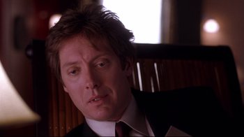 Movie still from “Secretary” (2002), directed by Steven Shainberg – A person wearing a suit and tie; Close Up shot, Over the shoulder angle