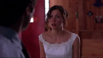Movie still from “Secretary” (2002), directed by Steven Shainberg – A woman in a wedding dress looking at a man; Close Up shot, Over the shoulder angle
