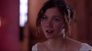 Movie still from “Secretary” (2002), directed by Steven Shainberg – A person looking at the camera; Close Up shot, Over the shoulder angle