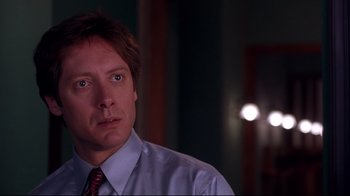 Movie still from “Secretary” (2002), directed by Steven Shainberg – A person wearing a shirt and a tie; Close Up shot, Over the shoulder angle