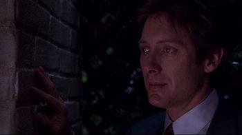 Movie still from “Secretary” (2002), directed by Steven Shainberg – A person wearing a suit and tie; Close Up shot, Low angle