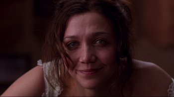 Movie still from “Secretary” (2002), directed by Steven Shainberg – A woman's face in a dark room; Close Up shot, Over the shoulder angle