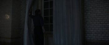 Movie still from “1899” (2022), created by Jantje Friese – A man standing in front of a window at night; Wide shot, Low angle