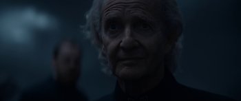 Movie still from “1899” (2022), created by Jantje Friese – An old woman is looking into the distance; Close Up shot, Low angle
